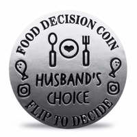 A round silver-toned coin-style token with engraved black text reading 'FOOD DECISION COIN' and 'HUSBAND'S CHOICE' plus 'FLIP TO DECIDE', surrounded by simple food and decision icons on a white background. Available at one more coin store