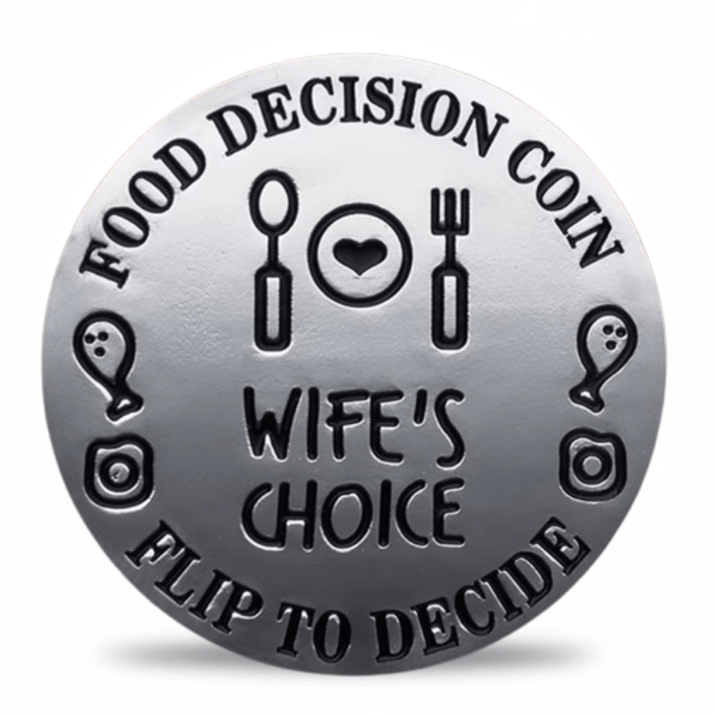 A round silver-toned metal coin-style token with engraved black text reading 'FOOD DECISION COIN' and 'FLIP TO DECIDE,' plus 'WIFE'S CHOICE' in the center and simple food-themed icons around the border.