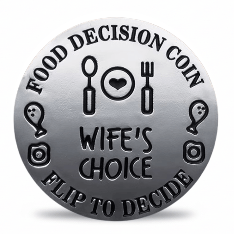 A round silver-toned metal coin-style token with engraved black text reading 'FOOD DECISION COIN' and 'FLIP TO DECIDE,' plus 'WIFE'S CHOICE' in the center and simple food-themed icons around the border.