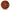 Round decorative item with 'I love you' text in multiple languages and a blue heart in the center on a red background.