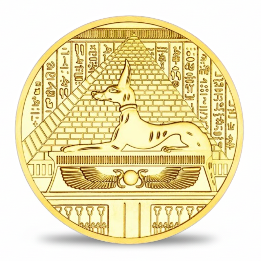 A round gold-colored commemorative coin featuring an Egyptian reed lion over a sarcophagus with hieroglyphic symbols, shown on a white background with a soft shadow.