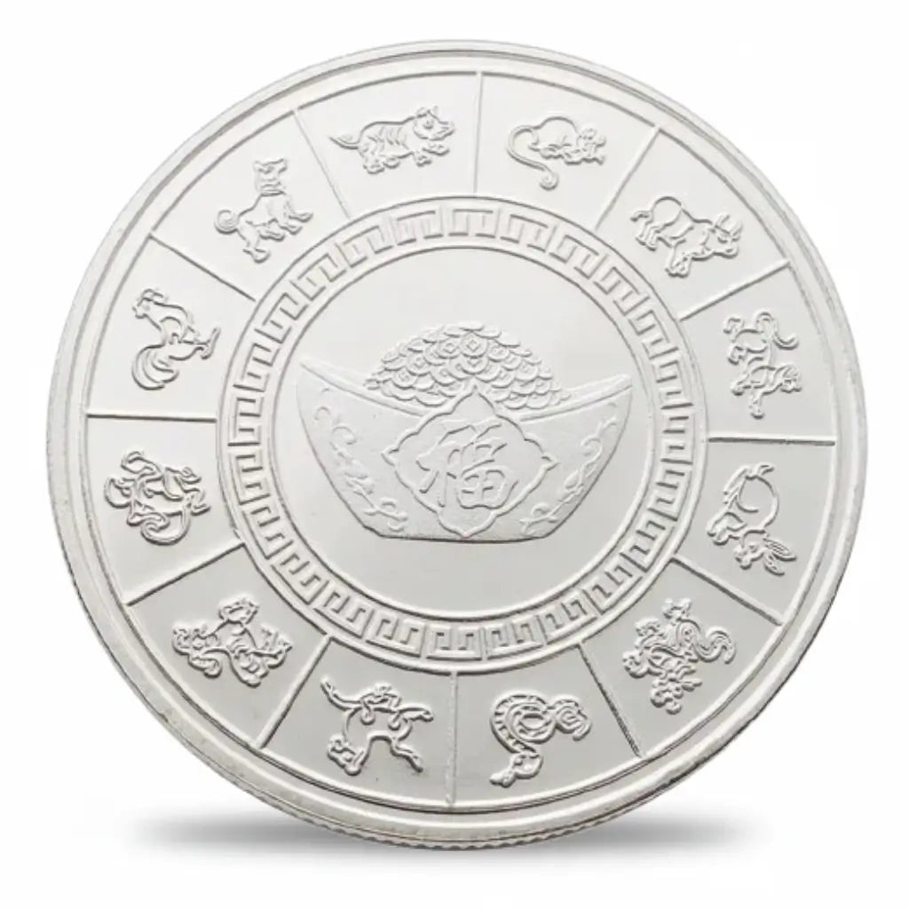 Silver-tone betta fish coin reverse showing twelve Chinese zodiac animals around the outer ring, with a geometric inner border surrounding an ingot motif and a pile of coins at the centre, collectible token
