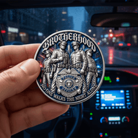 A hand holds a round silver-toned police brotherhood coin in front of a blurred car dashboard and night street scene. The coin features sculpted officers and the words 'Brotherhood' and 'No One Walks the Night Alone.