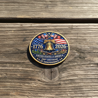 Independence Day coin reverse side lying flat on worn wooden surface natural daylight 1776 2026 Liberty Bell commemorative collectible token
