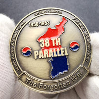 Korean War 38th Parallel challenge coin held in white gloves showing enamel map detail and antique gold finish
