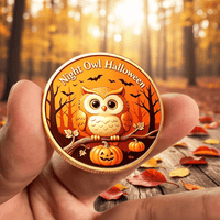 A hand holds a round gold-toned commemorative coin featuring an owl perched on a pumpkin branch with the text 'Night Owl Halloween' against an orange autumn forest background. The scene is set outdoors on a wooden surface with scattered leaves, with a blurred forest backdrop.
