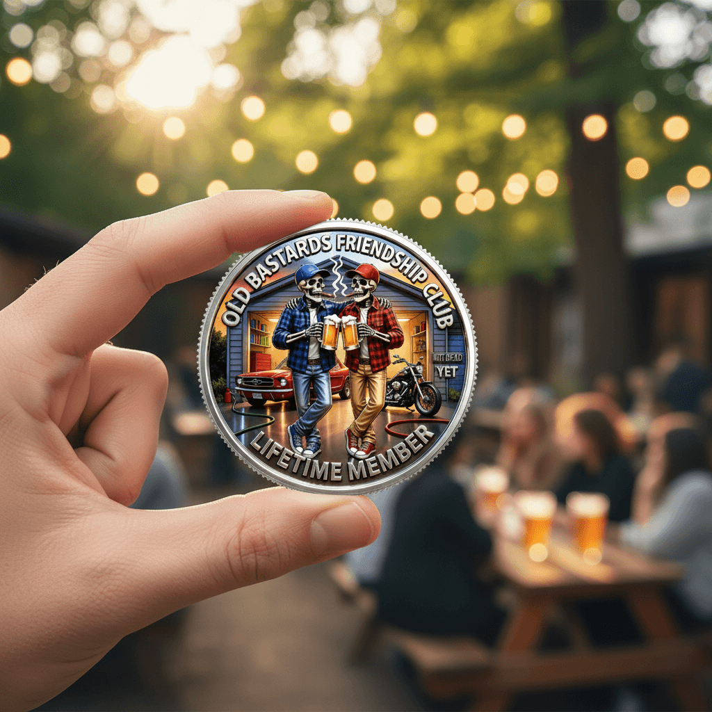 Hand holding Old Bastards Friendship Club Lifetime Member coin outdoors beer garden novelty collectible gift for men
