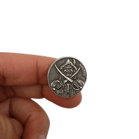 Close-up of pirate skull hobo nickel collectible coin token showing antique silver-tone relief detail
