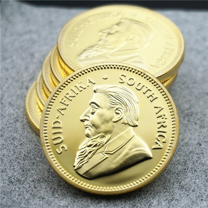 South African Krugerrand gold-tone replica coins stacked Paul Kruger portrait collectible coin display available at One More Coin store
