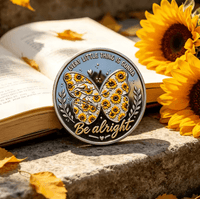 Butterfly-shaped coin with sunflower design on an open book with sunflowers around