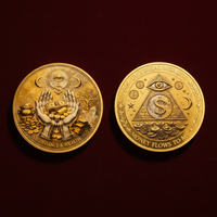 Universal Wealth and Abundance manifestation collectible coin both sides displayed on dark velvet surface with warm golden lighting