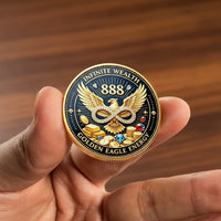 Hand holding Vault of Abundance 888 Golden Eagle coin showing infinite wealth 888 golden eagle diamond infinity symbol gold bars gemstones black enamel prosperity collectible