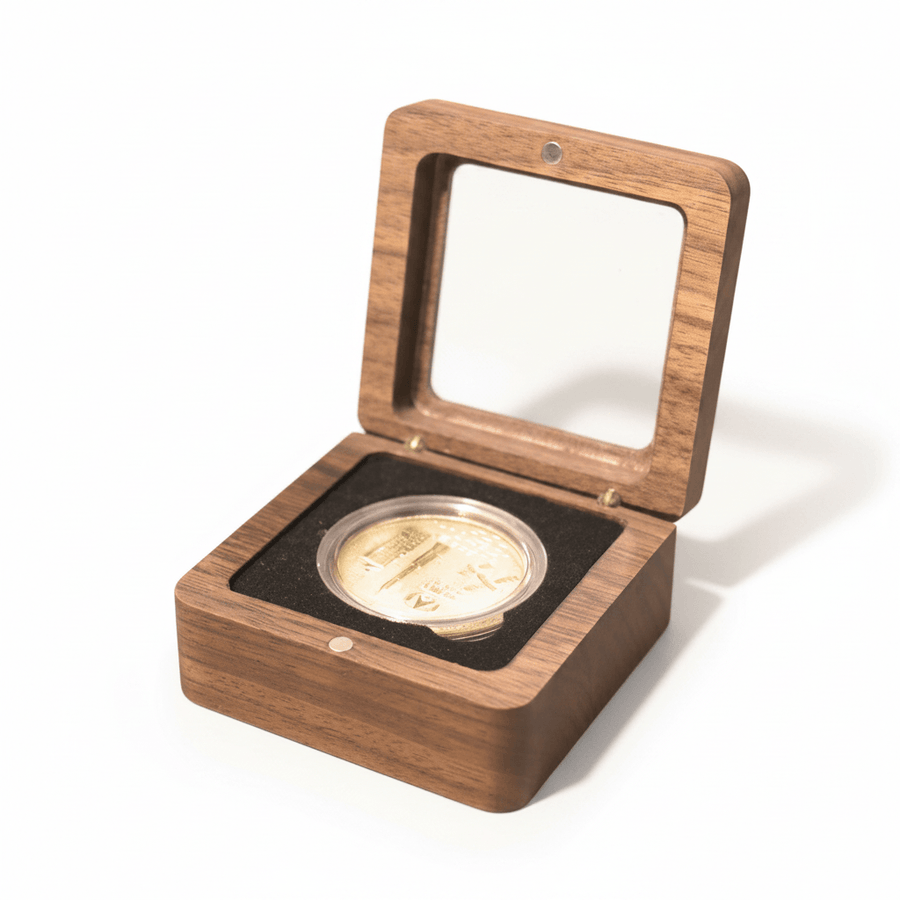 Walnut coin display box with black velvet interior holding a gold collectible coin.
