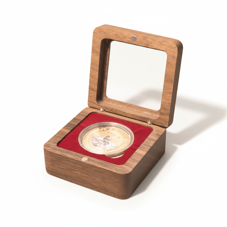 Walnut coin display box with crimson velvet interior holding a gold collectible coin on white background

